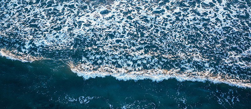 An aerial photo of waves coming into shore