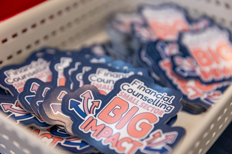 A tray of Small Sector, Big Impact stickers featuring the campaign's logo.