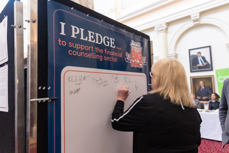Ros Spence MP adds her signature to the pledge wall in Queens Hall.