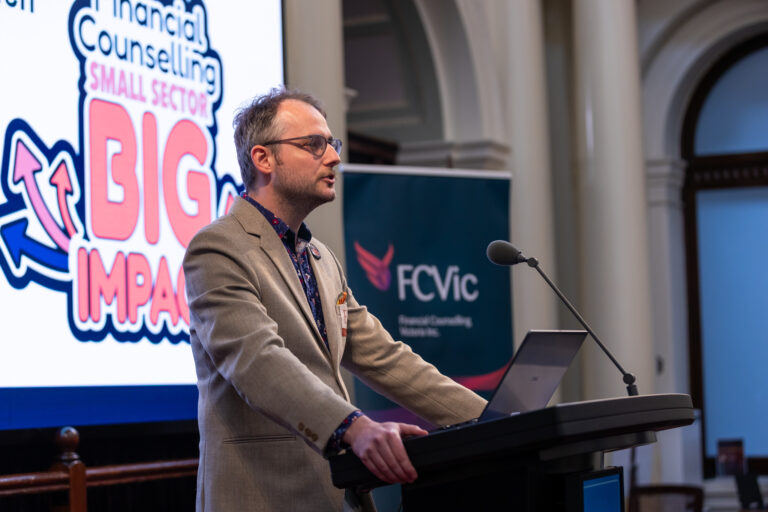 FCVic CEO Zyl Hovenga-Wauchope speaks at the podium in front of the Small Sector, Big Impact screen.