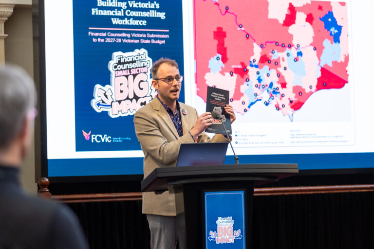 FCVic CEO Zyl Hovenga-Wauchope holds up the "Building Victoria's Financial Counselling Workforce" submission booklet.