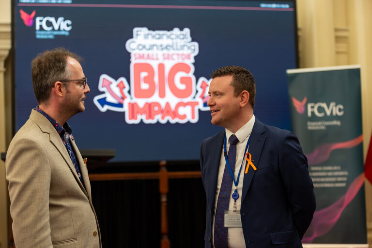 FCVic CEO Zyl Hovenga-Wauchope and the Hon. Tim Richardson MP talking beside the FCVic banner and Small Sector, Big Impact branding.