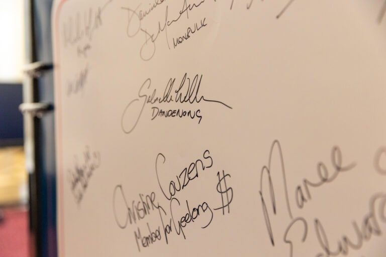 Close-up of signatures on the pledge wall, including Christine Couzens MP, Member for Geelong.