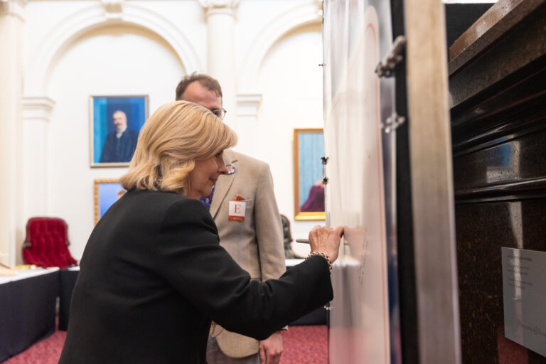 Kim O'Keefe signs the pledge wall.