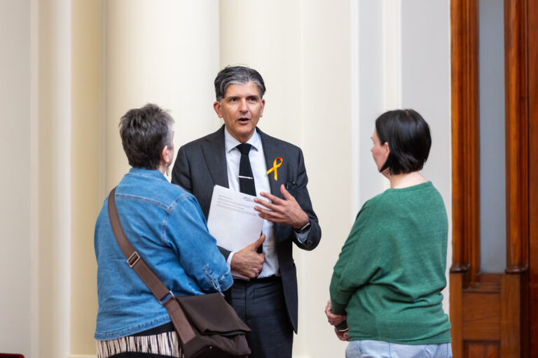 Gary Maas MP speaks with two attendees in Queens Hall.