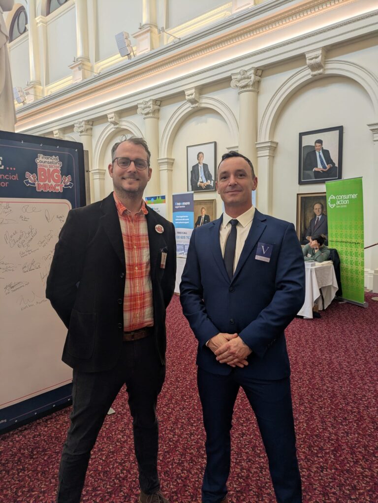 State Leader and State President of One Nation Victoria, Warren Pickering, stands with FCVic's CEO beside the "I Pledge" board in Queen's Hall.