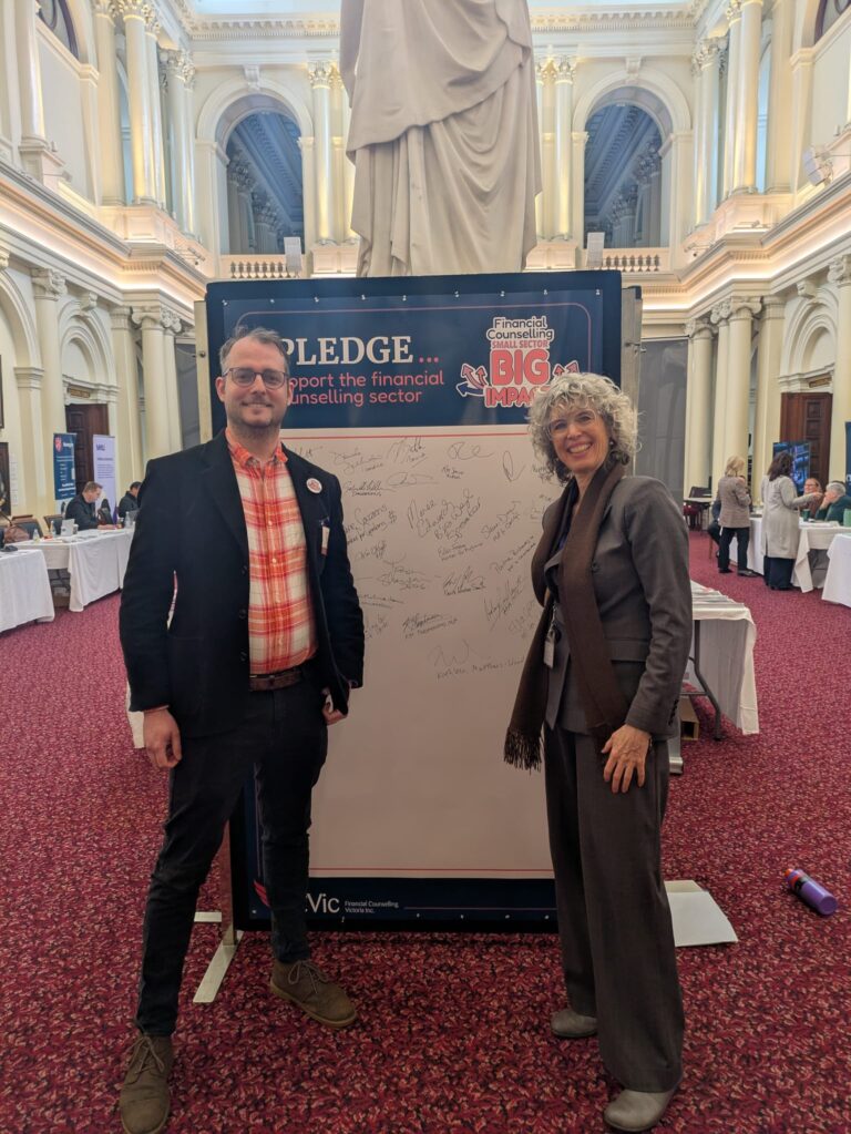 Nina Taylor MP stands beside an attendee at the "I Pledge" board in Queen's Hall.