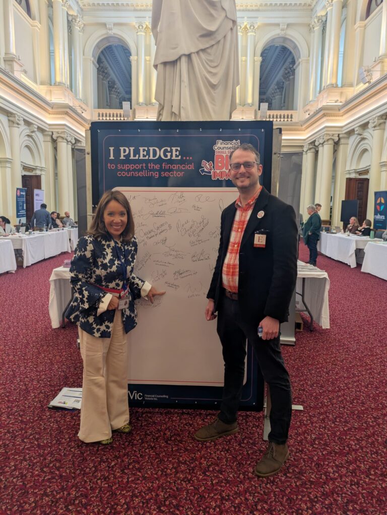Rachel Westaway MP stands beside FCVic's CEO at the "I Pledge" board in Queen's Hall.
