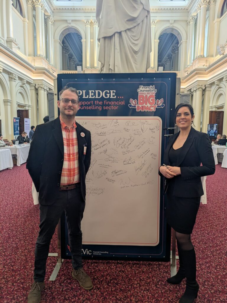 FCVic's CEO stands beside Moira Deeming MP at the "I Pledge" board in Queen's Hall.