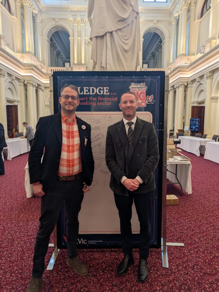 FCVic's CEO stands with Dylan Wight MP at the "I Pledge" board in Queen's Hall.