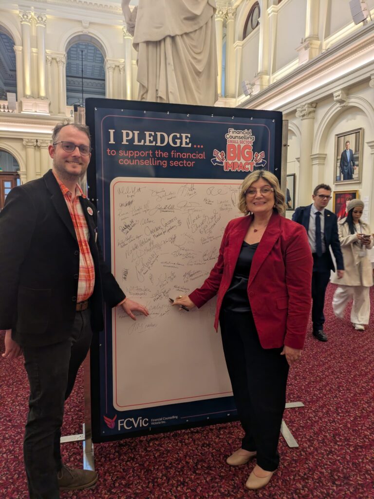 FCVic's CEO and The Hon. Natalie Suleyman sign the "I Pledge" board together in Queen's Hall.