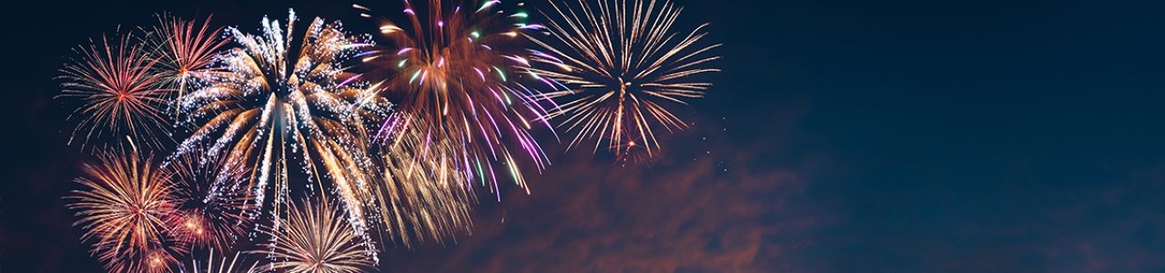 A photograph of a dusky evening sky with fireworks